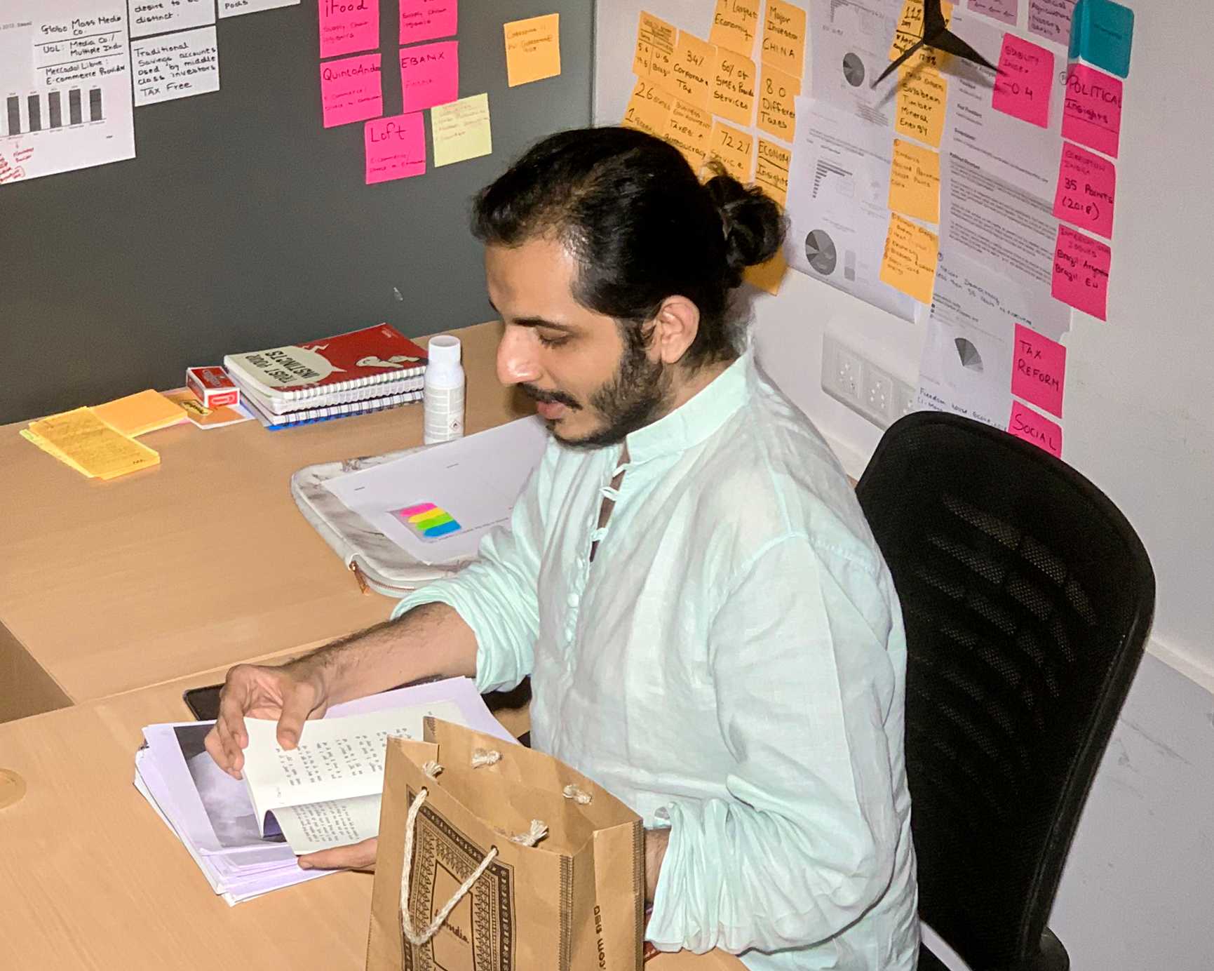 A copywriter sitting on his desk and reading something